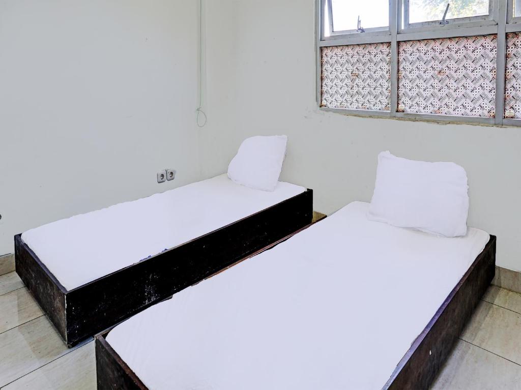 เตียงในห้องที่ SPOT ON 92374 Penginapan Rusunawa