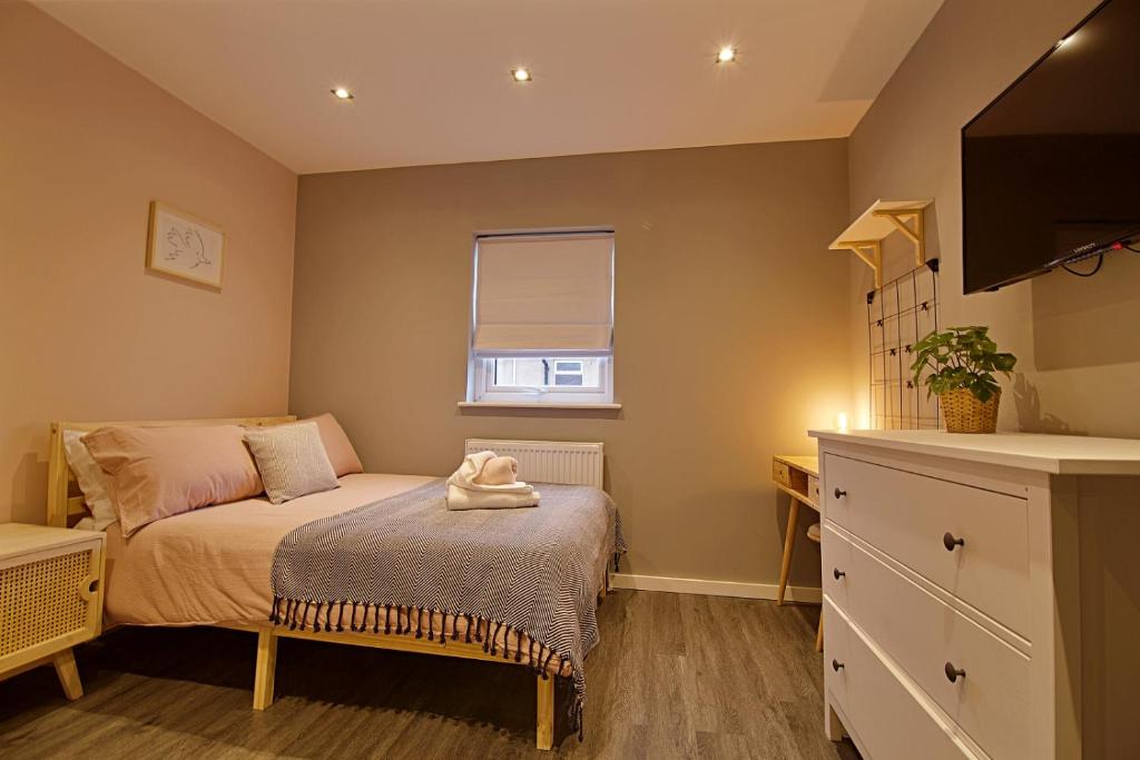 a small bedroom with a bed and a window at 'Bellerose' at stayBOOM in Scotforth