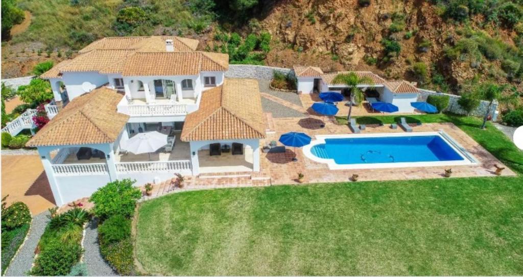 an aerial view of a house with a swimming pool at Villa Mirador de Valtocado in Mijas