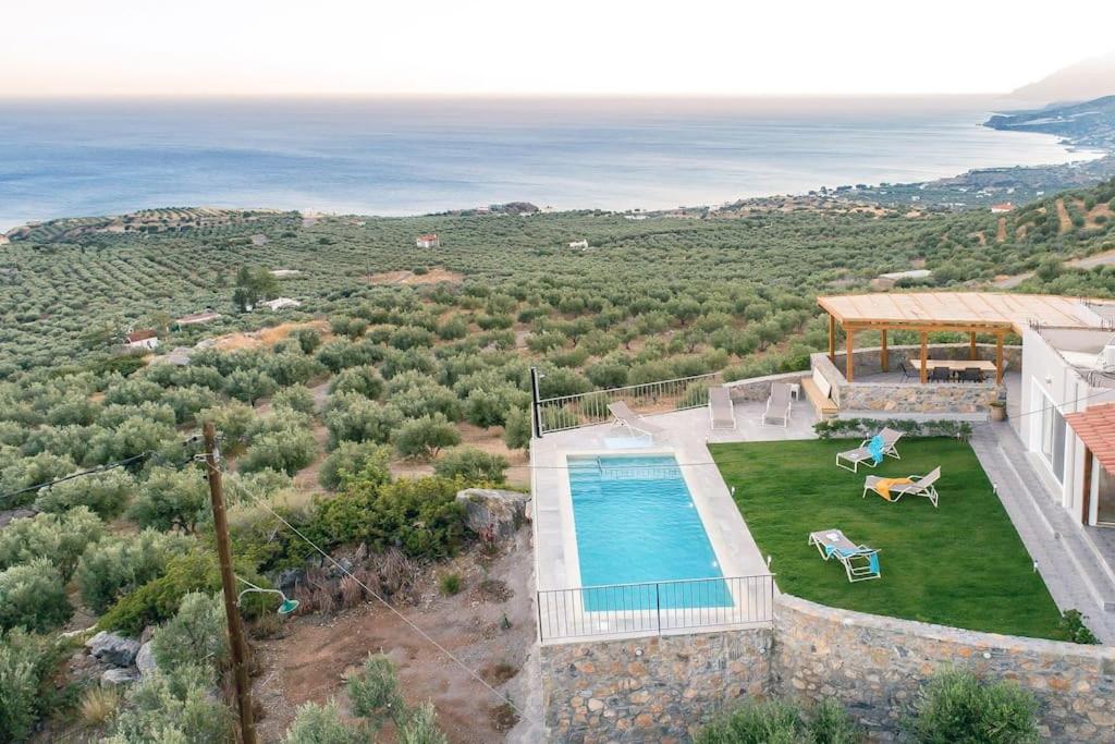 an aerial view of a house with a swimming pool at Villa Panthea in Keratokampos