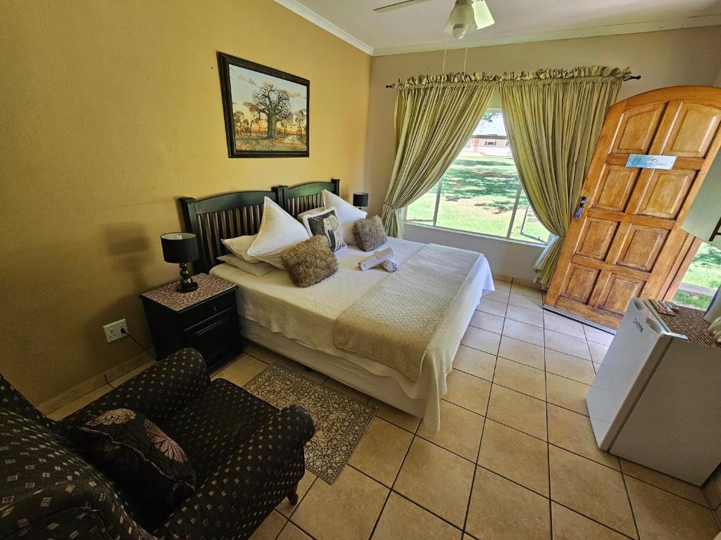 a bedroom with a bed and a sliding door at Aloetree Cloves room in Krugersdorp