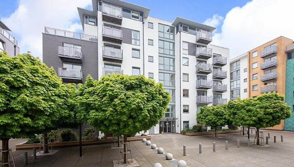 a large apartment building with trees in front of it at Apartment Central London in London