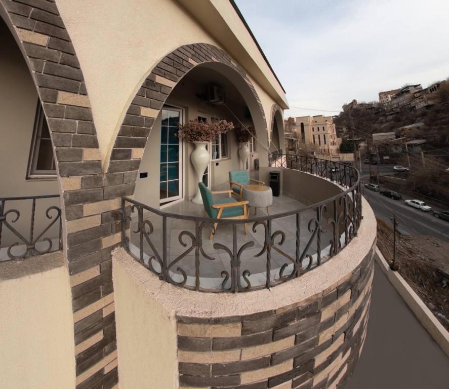 a balcony of a building with a chair on it at La Casa Hotel Yerevan in Yerevan