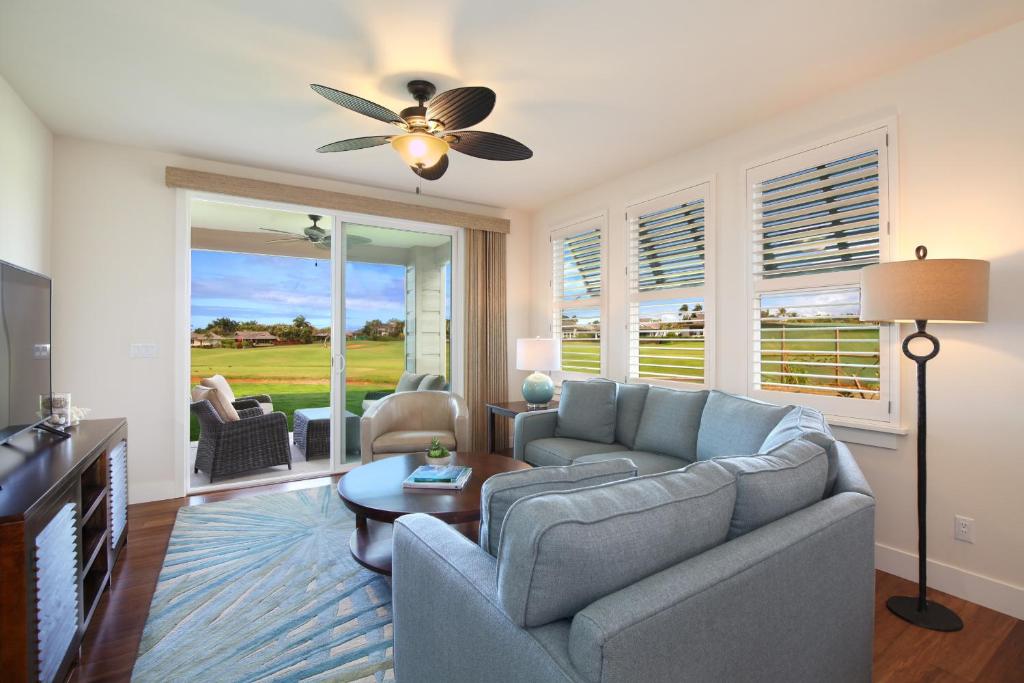 a living room with a couch and a ceiling fan at Pili Mai 7M in Koloa