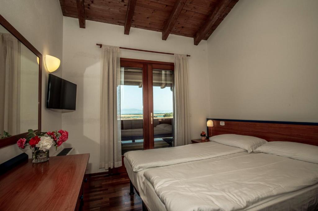 Postel nebo postele na pokoji v ubytování Hotel Caneo