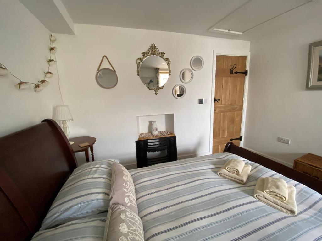 a bedroom with a bed with two towels on it at Dugdales Cottage in Settle