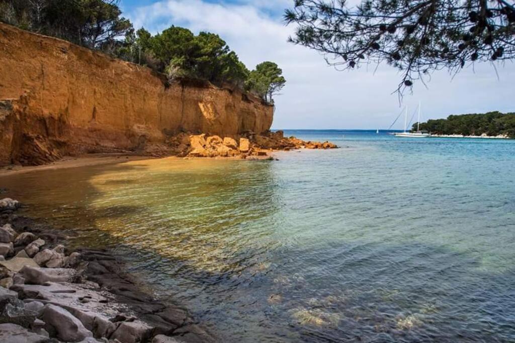 a view of a beach with a boat in the water at Apartman Milica in Vrgada