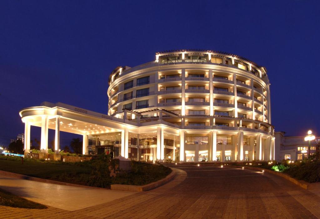 a large white building with lights on it at night at Enjoy Viña Del Mar in Viña del Mar