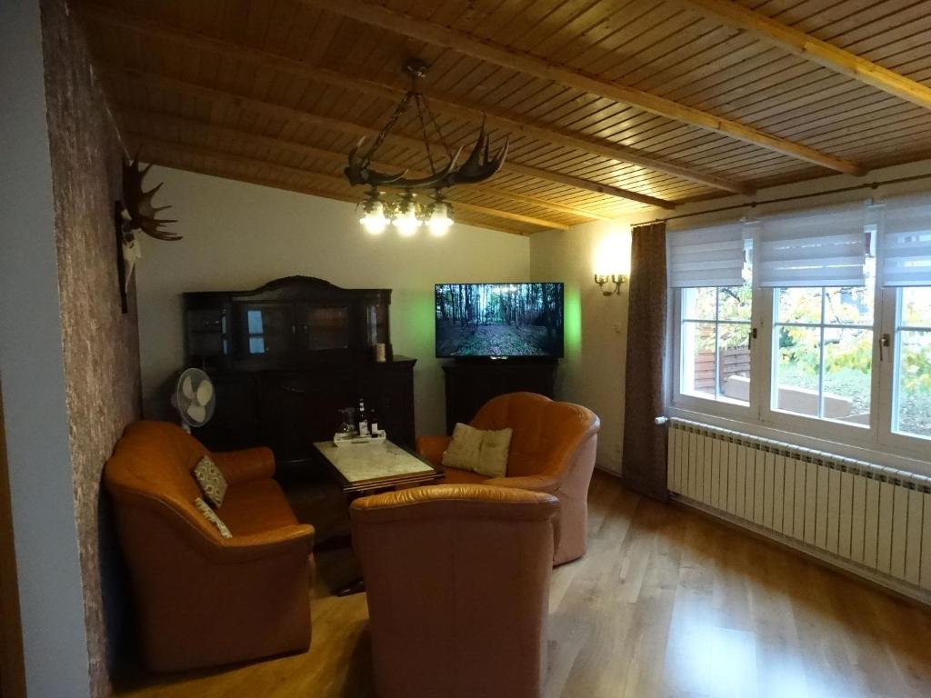 a living room with chairs and a table and a window at Schwedenhaus in Mönkebude