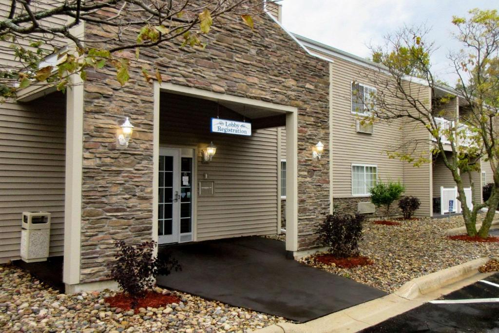 a brick house with a garage with a driveway at Quality Inn & Suites Red Wing in Red Wing
