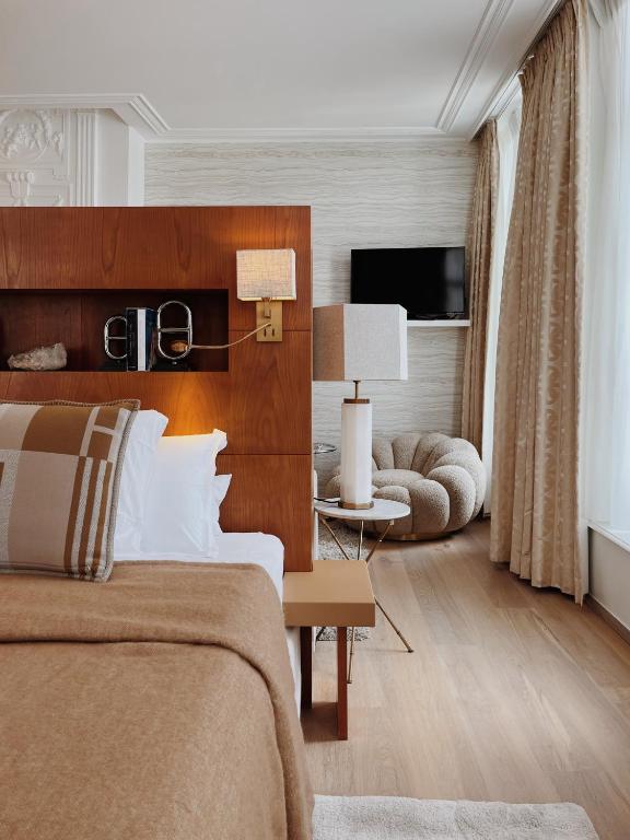 a bedroom with a bed and a living room at Hotel Van Cleef in Bruges