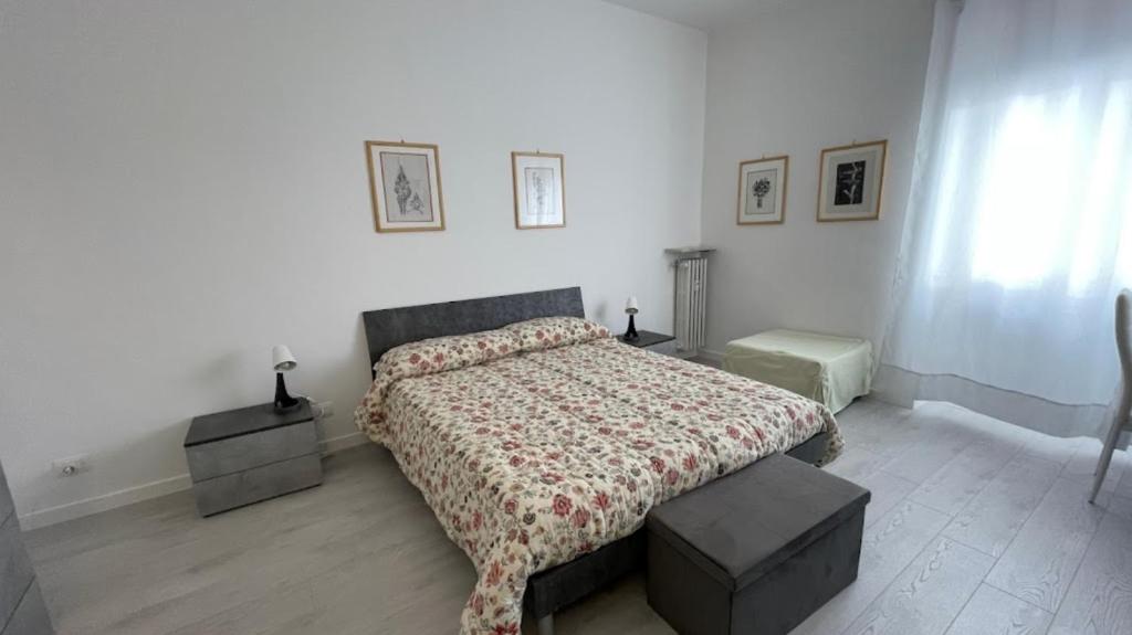 a bedroom with a bed with a comforter on it at BnB Arianna's home in Turin
