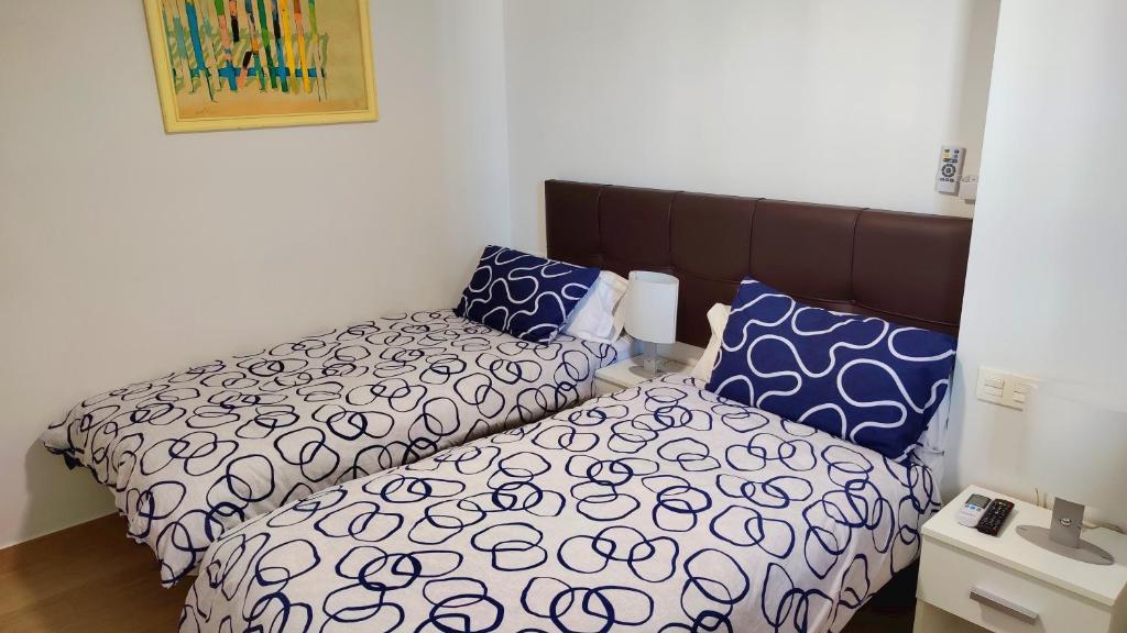 A bed or beds in a room at BEACHFRONT -- NEW LUXURY Apartment -- 1ª Linea Playa -- Fuengirola CITY CENTER -- Private PARKING -- Panoramic Sea Views --