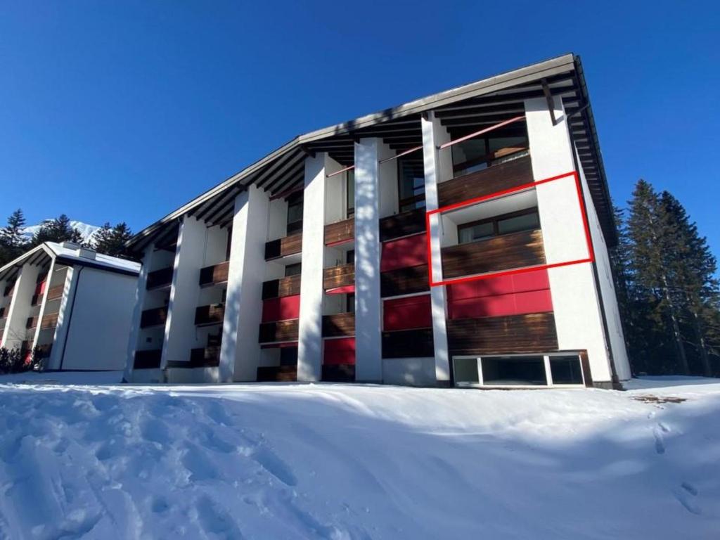 a building with snow in front of it at Apartment Uehlinger La Riva 307 by Interhome in Lenzerheide