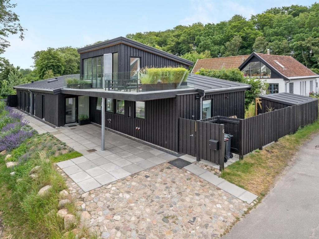 an image of a house with a black exterior at Holiday Home Ebke - 70m from the sea in Sealand by Interhome in Gilleleje