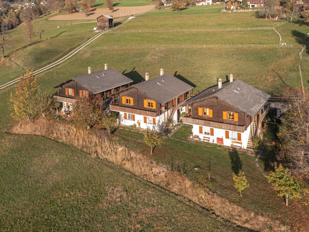 una vista aérea de una casa grande en un campo en Apartment Chalet Niderärne by Interhome en Lax