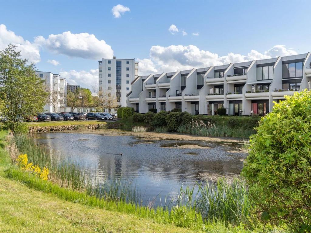 a building next to a river in front of a building at Apartment Liv - 50m from the sea in Sealand by Interhome in Helsingør