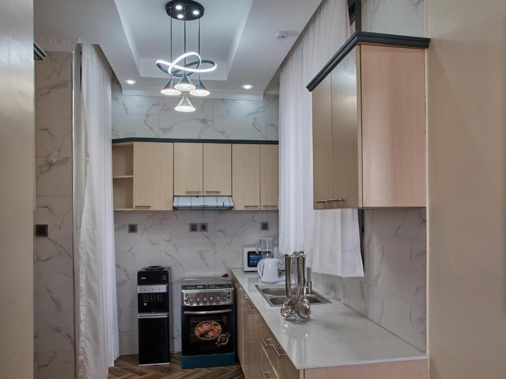 a kitchen with white marble counters and a ceiling at Unique Aaprtment in Kigali