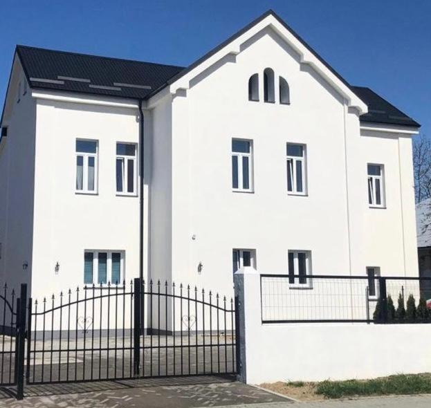 a white house with a fence in front of it at Apartman 7- Vila Stefanik in Trenčianska Teplá