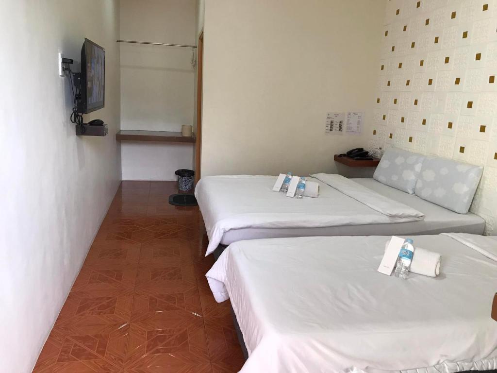 Postel nebo postele na pokoji v ubytování I'm Inn Hotel Sorsogon near SM or Terminal