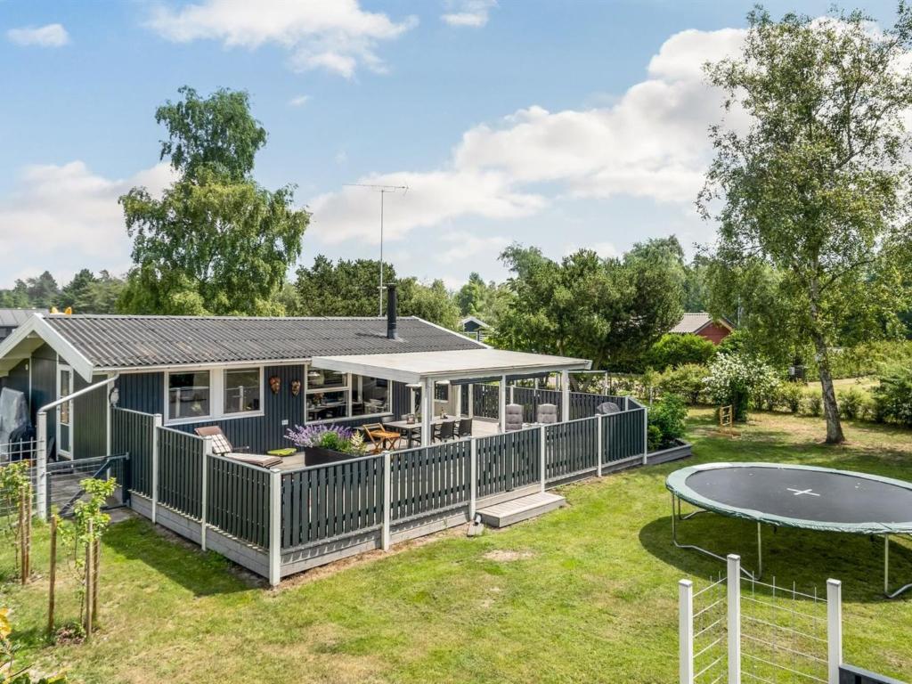 a house with a pool and a trampoline at Holiday Home Dierf - 550m from the sea by Interhome in Gedser
