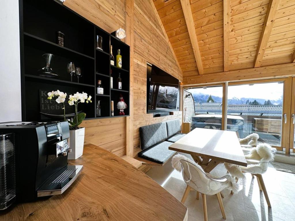a living room with a table and a couch at Maisonette-Apartment Das Garmisch mit Whirlpool in Garmisch-Partenkirchen
