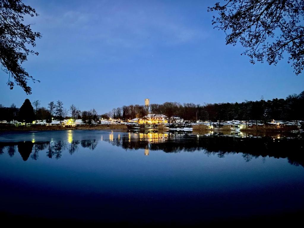 a view of a lake at night at Gasthof Seeklause in Pfedelbach
