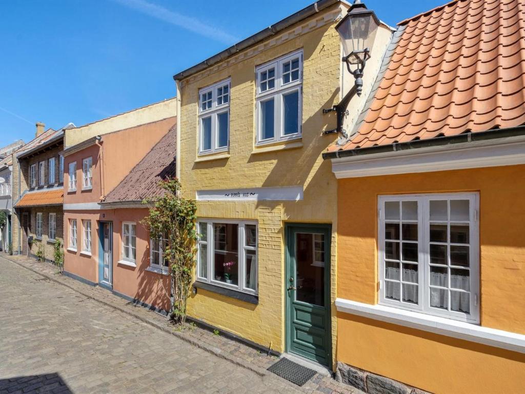 a row of colourful houses on a street at Holiday Home Laust - 250m from the sea in Funen by Interhome in Faaborg