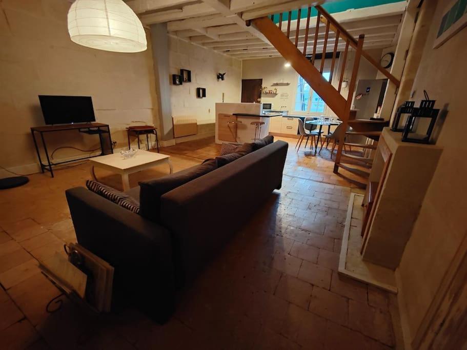 a living room with a couch and a table at Charmant Duplex Rue Colbert in Tours