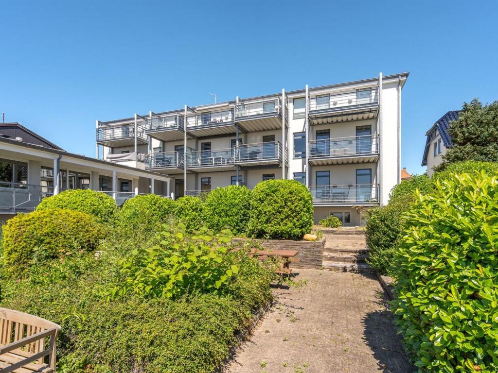 an apartment building with bushes in front of it at Apartment Axlan - 50m from the sea in Funen by Interhome in Tranekær