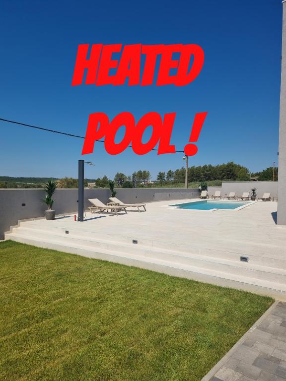 a red sign that reads heard rook next to a pool at Villa Madison in Posedarje