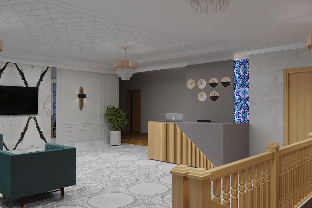 a lobby with a staircase and a reception desk at Xabib&son's hotel in Bukhara