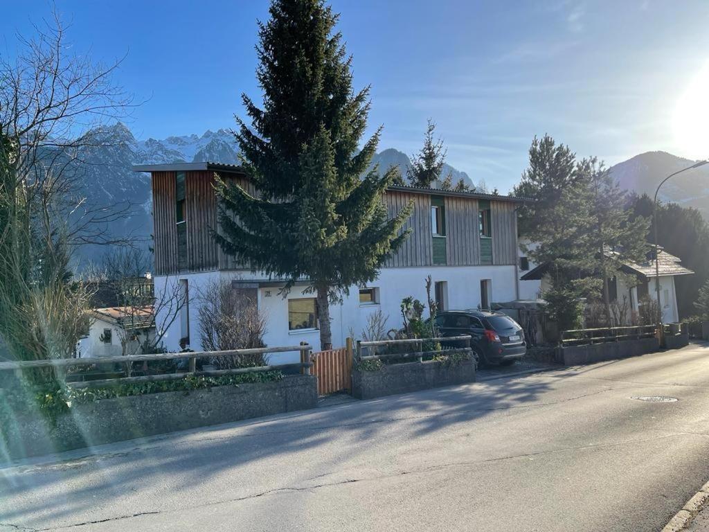 a house on the side of a road at Kiwi Ferienwohnung in Bludenz