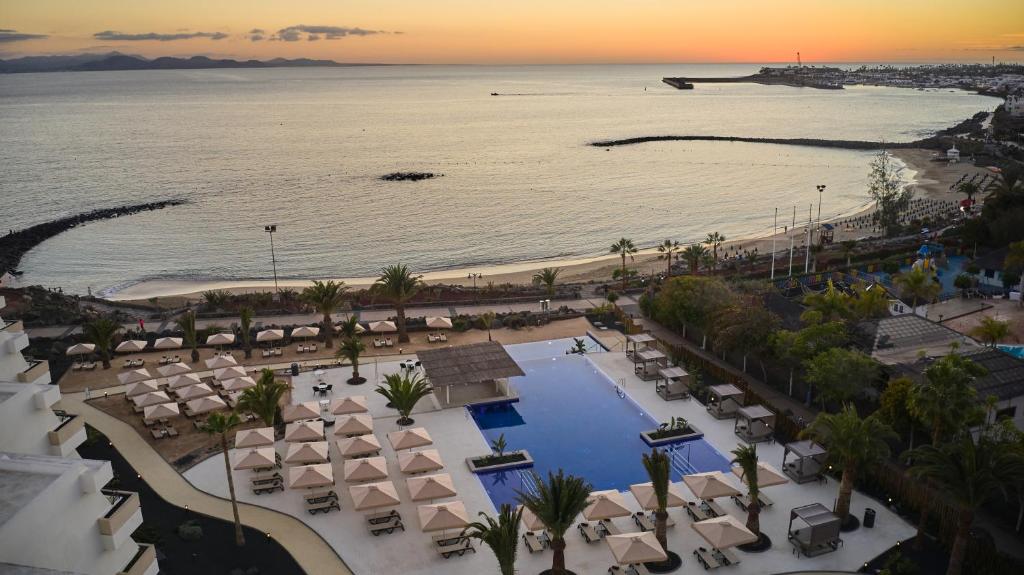 an aerial view of a resort with a pool and a beach at Dreams Lanzarote Playa Dorada Resort & Spa in Playa Blanca