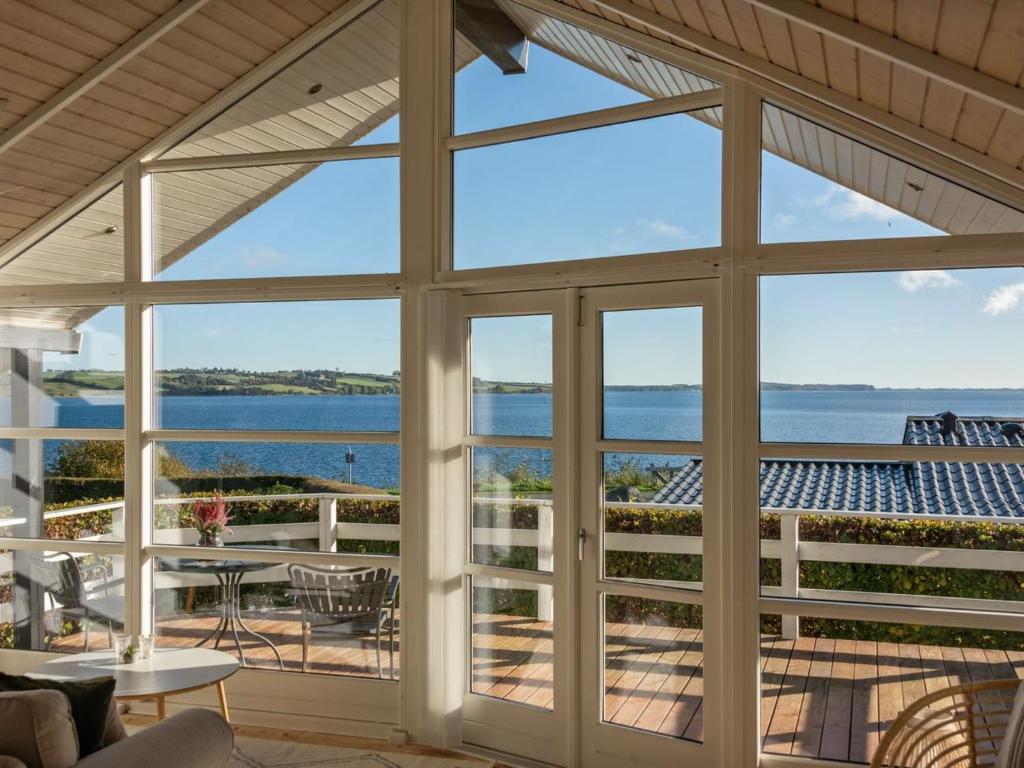 aus einem Haus mit Glastüren und Meerblick in der Unterkunft Holiday Home Nica - 100m from the sea in SE Jutland by Interhome in Broager