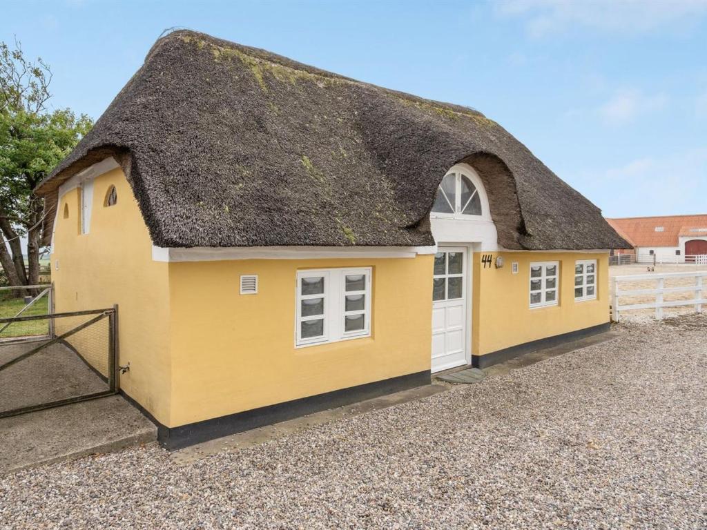 a yellow building with a thatched roof at Holiday Home Miko - 19km from the sea in Western Jutland by Interhome in Skærbæk