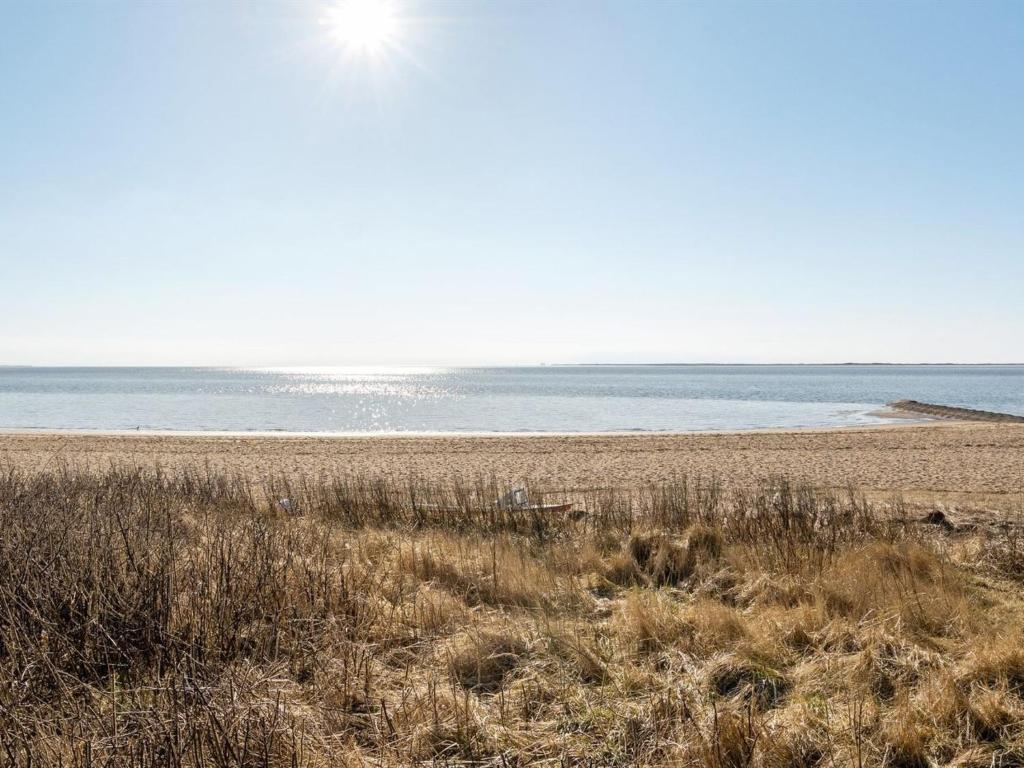 a sandy beach with the ocean in the background at Apartment Herkko - 25m from the sea in Western Jutland by Interhome in Esbjerg