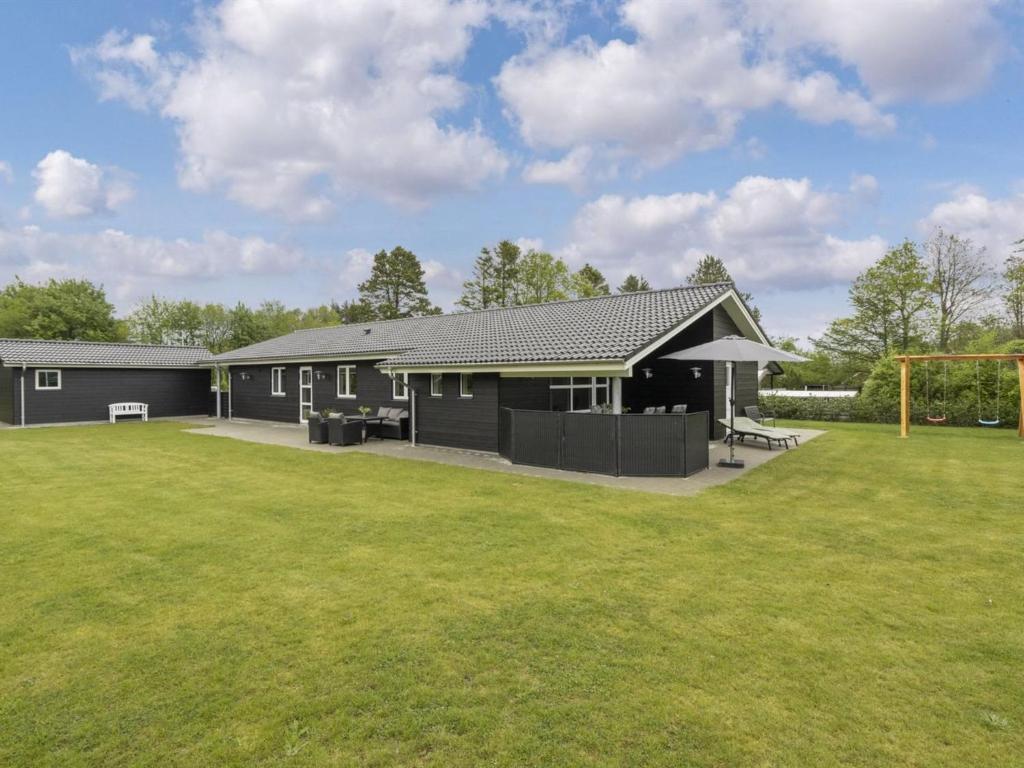 a house with a soccer field in the yard at Holiday Home Gardi - 14km from the sea by Interhome in Oksbøl