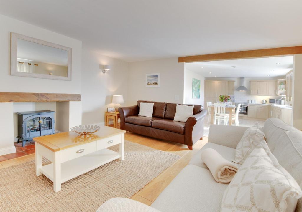 a living room with a couch and a table at Oak Lodge in Alderford