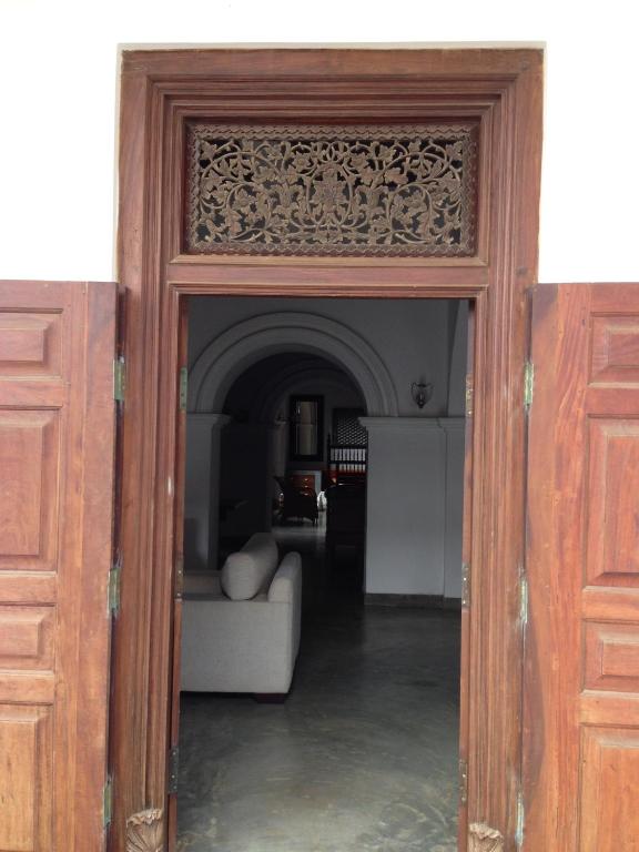 an open door into a living room with a couch at Khalid's Guest House in Galle