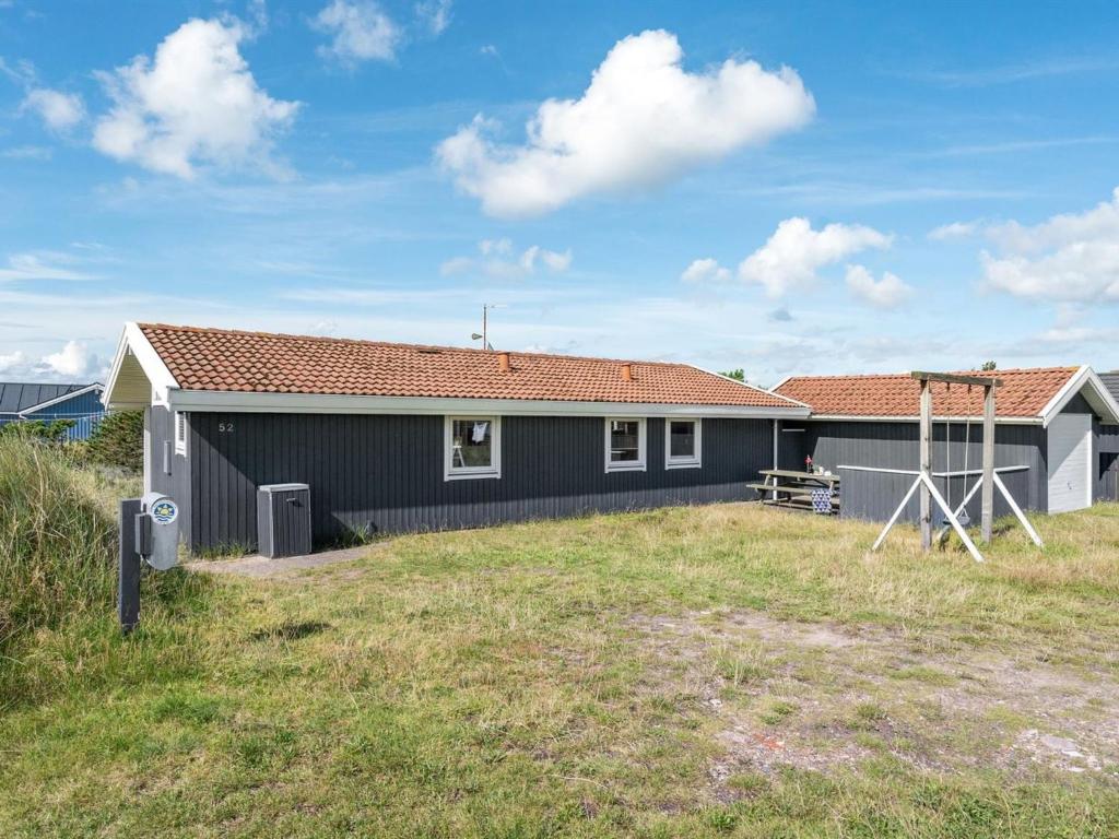 a small house with a yard in front of it at Holiday Home Siri - 400m from the sea in NW Jutland by Interhome in Thisted