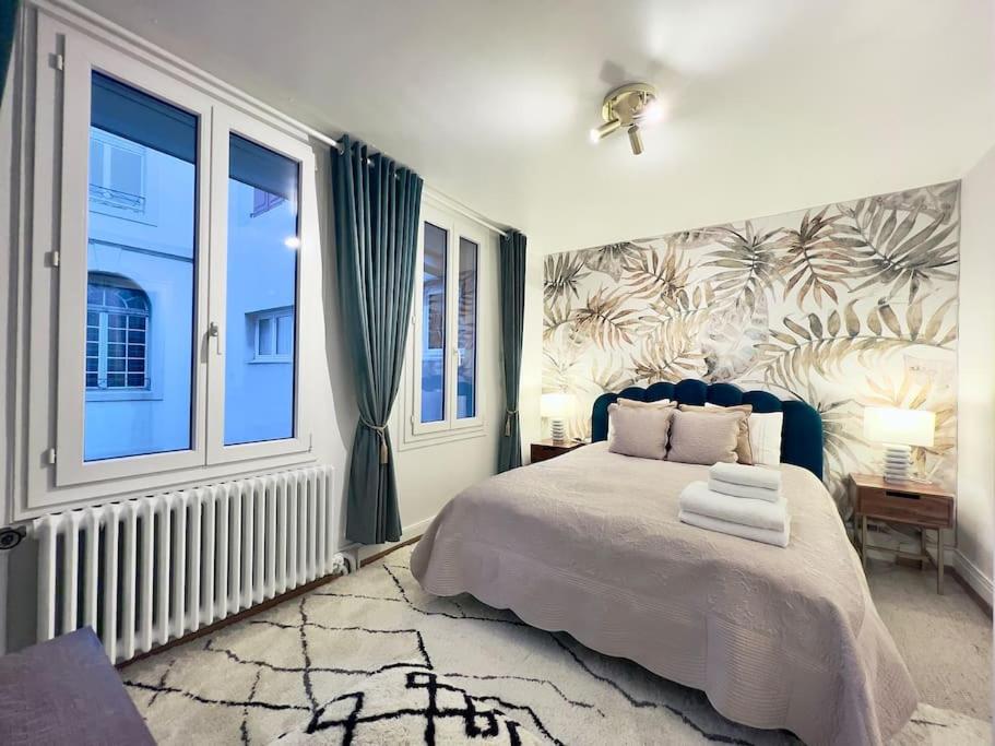 a bedroom with a bed and a large window at Exquisite one-bedroom apartment on Av du Casino in Montreux