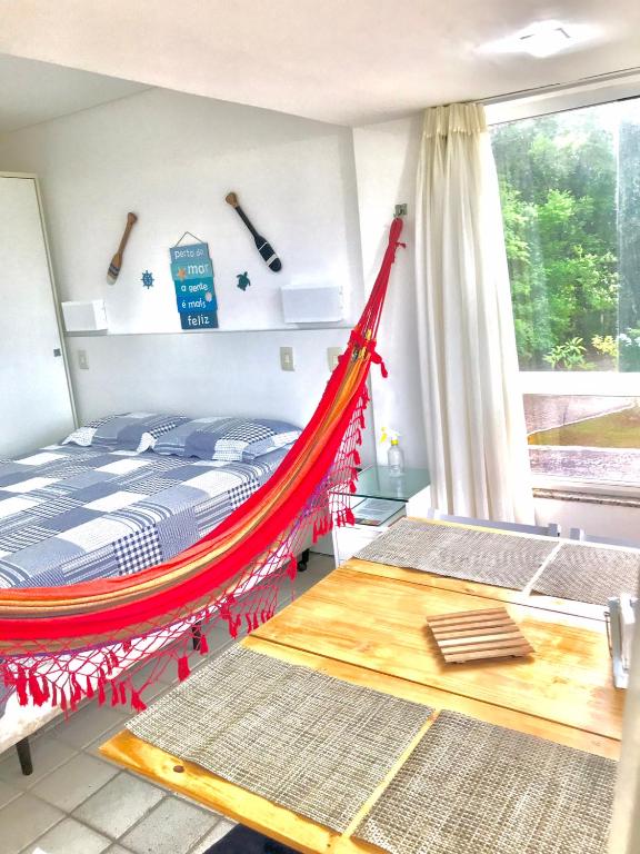 a hammock bed in a room with a window at Gavoa Resort - 2 quartos - BL D apt 209 in Igarassu