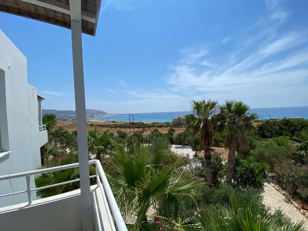 a view of the ocean from the balcony of a house at Hotel Plakures in Falasarna