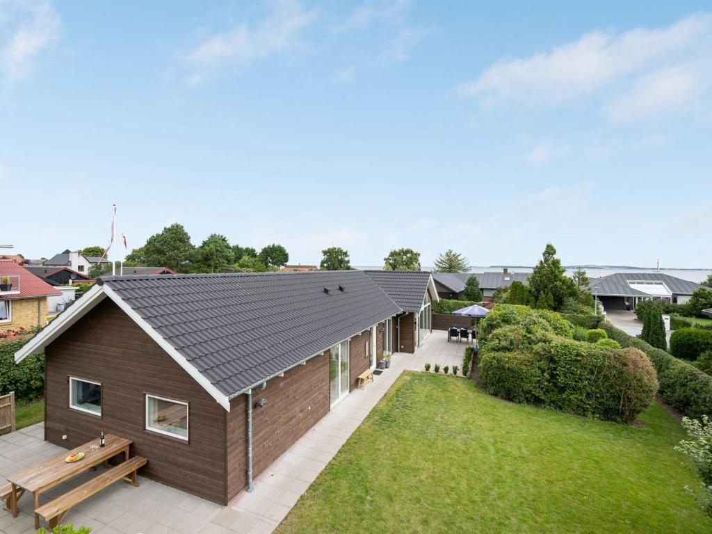 an exterior view of a house with a yard at Holiday Home Regni - 300m to the inlet in The Liim Fiord by Interhome in Nykøbing Mors