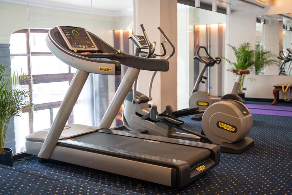 a gym with several cardio machines in a room at Hotel Kraft in Florence