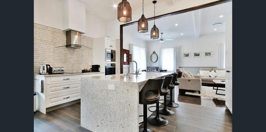 a kitchen with a counter and a living room at MJ's 2 bedroom luxury style apartment in Ipswich