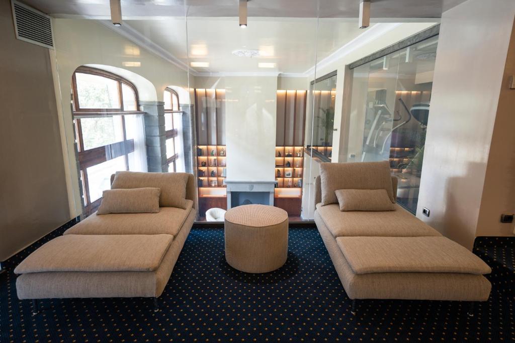 a living room with two couches and a table at Hotel Kraft in Florence