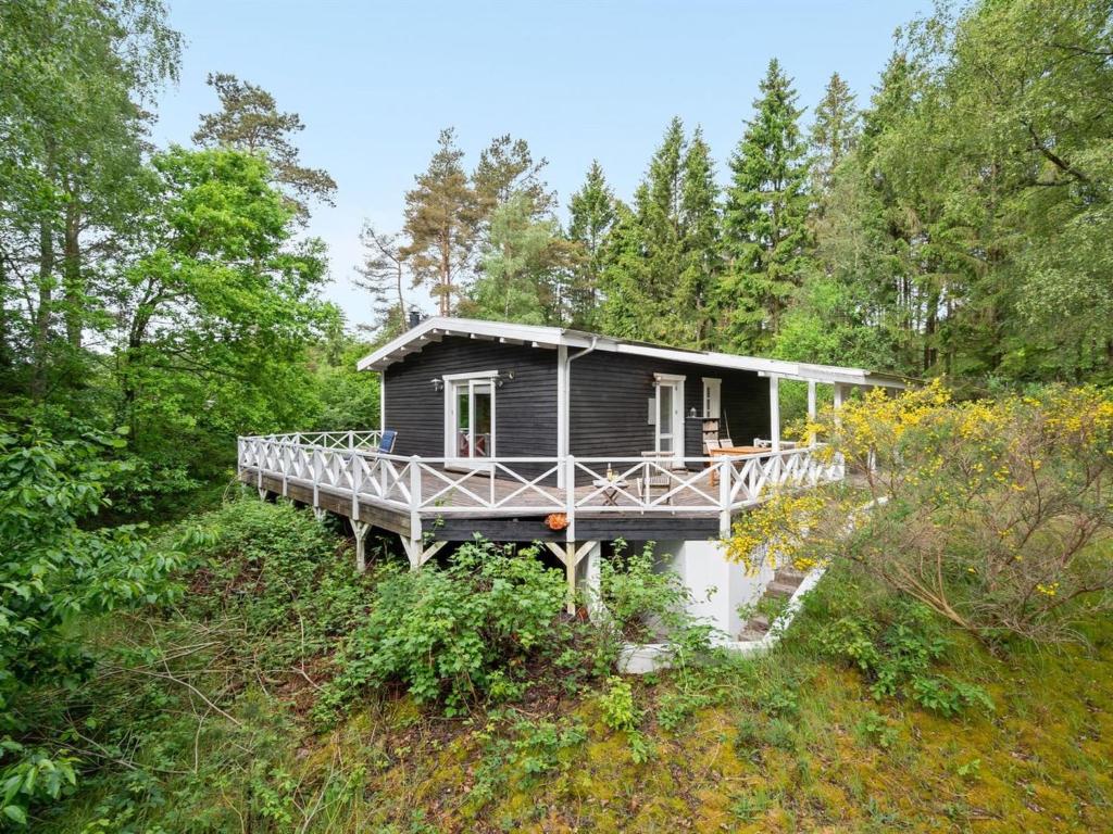 a house on a dock in the woods at Holiday Home Belenda in SE Jutland by Interhome in Silkeborg