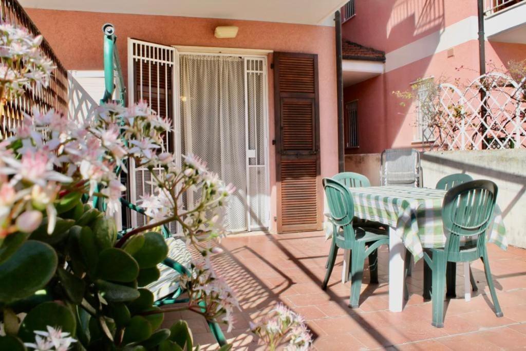 een patio met een tafel en stoelen op een balkon bij Terrazza a pochi passi dal mare in Loano